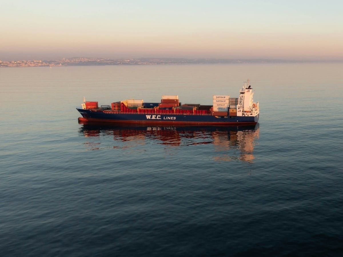 Container ship on a calm sea at dusk